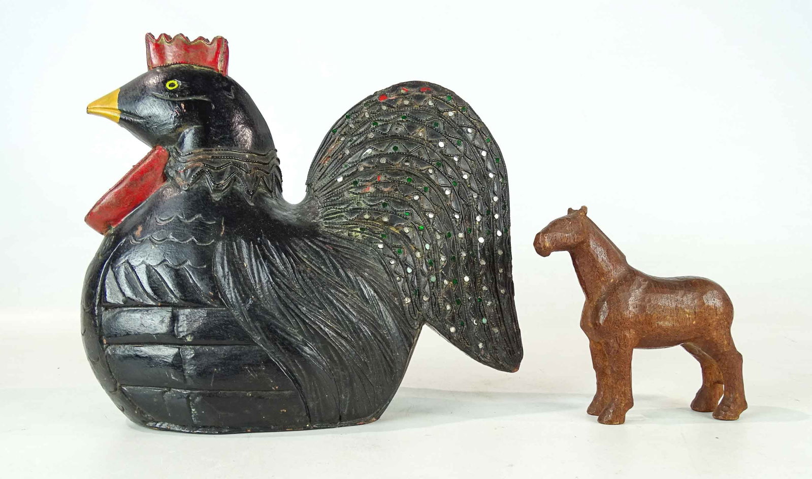 Folk Art Carvings: Lot including wooden folk art painted chicken (11" W., 9 1/2" Ht., jewels set in tail), and horse (5" W., 6" Ht.). Provenance: Ed and Anita Holden Collection.