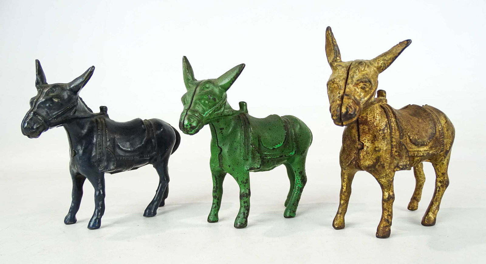 Bank Lot: Lot (3) 1913 Arcade cast iron donkey banks. (#499 Penny Bank Book). Tallest 4 3/4" Ht..