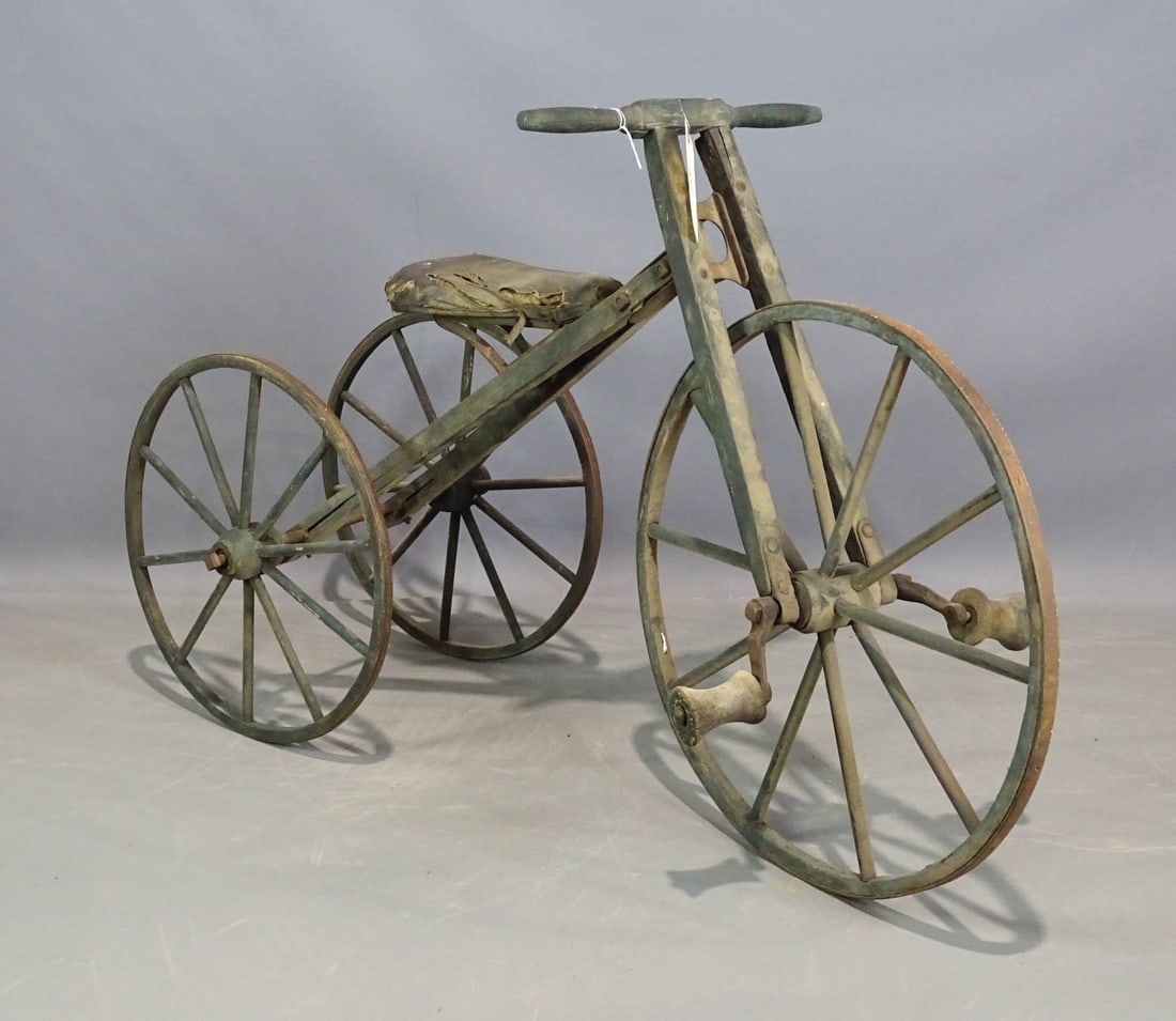 19th c. Wooden Tricycle: 19th c. wooden tricycle in old green paint. 24" front wheel, 18" rear wheels. Barn fresh condition. Provenance: Wayne & Kim Batten Collection.