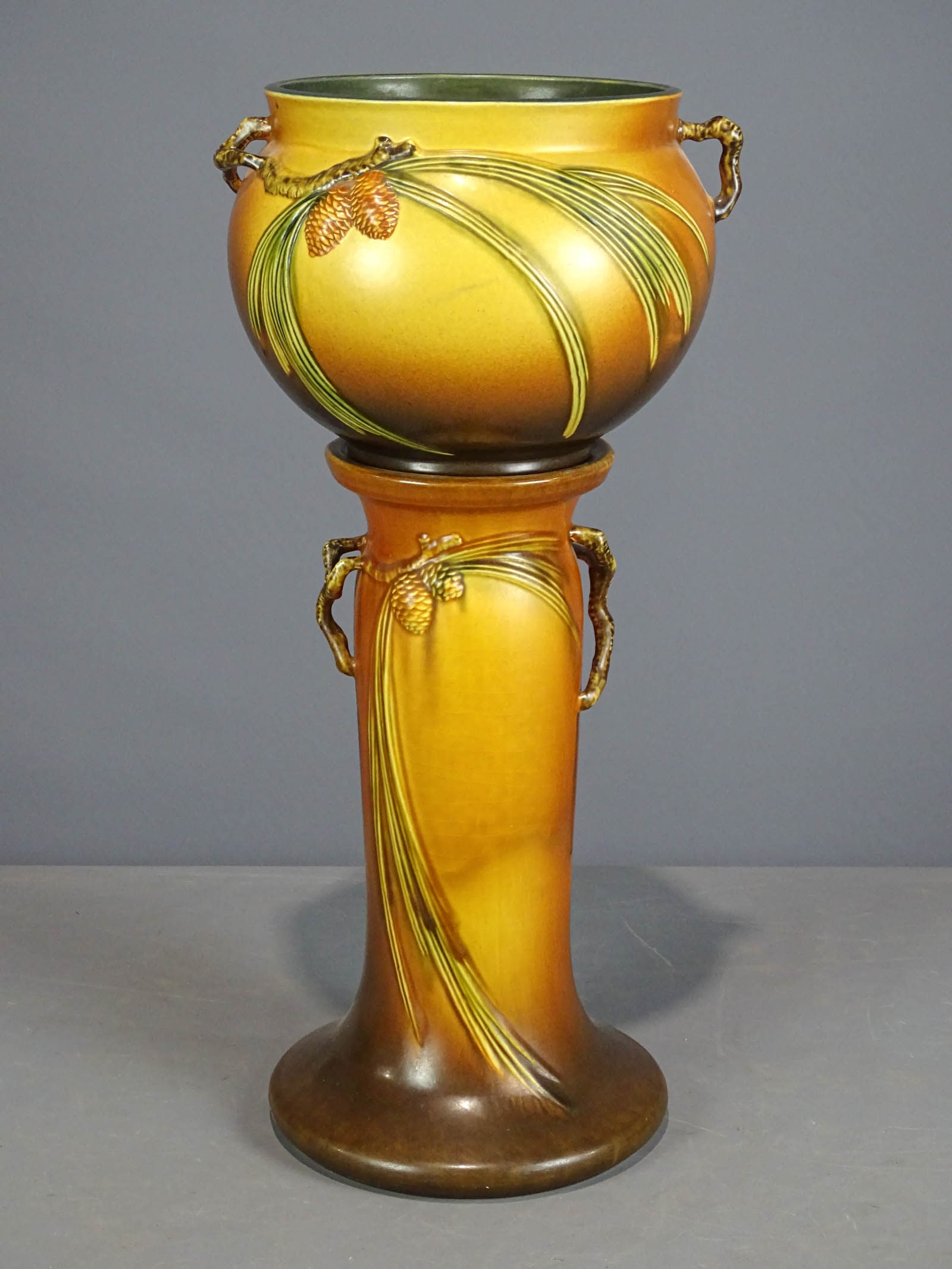 Roseville Jardiniere and Pedestal: Roseville Jardiniere and pedestal. Barbara Packer Collection. 25 1/2" Ht.. Hairline along rim of top, crazing to base, otherwise good condition.