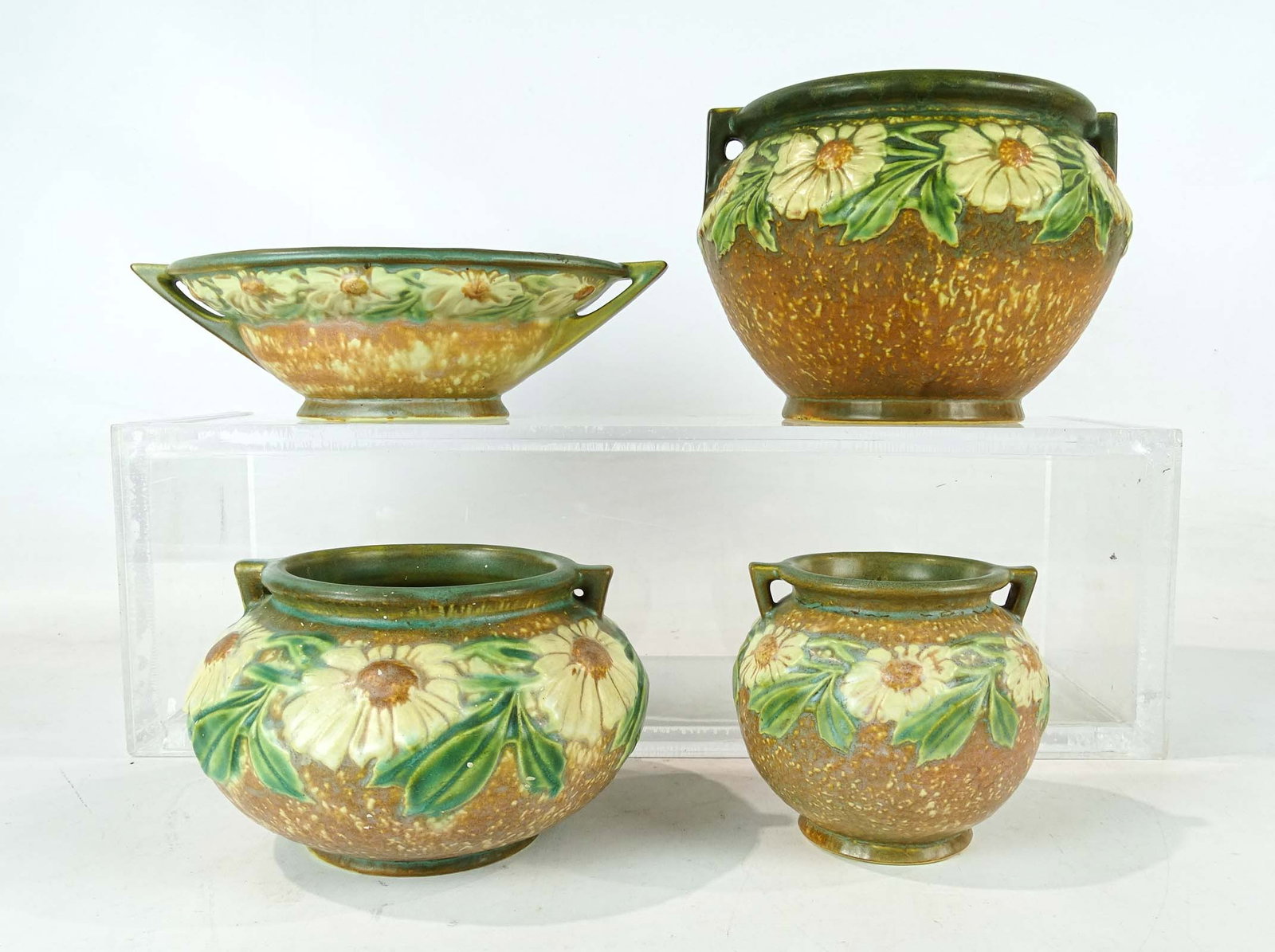 Roseville Lot: Lot (4) pieces of Roseville including planter (10 1/2" L.), and (3) vases (tallest 6 1/2" Ht.). Barbara Packer collection. One with minor spidering to base, one cracked, otherwise good condition.