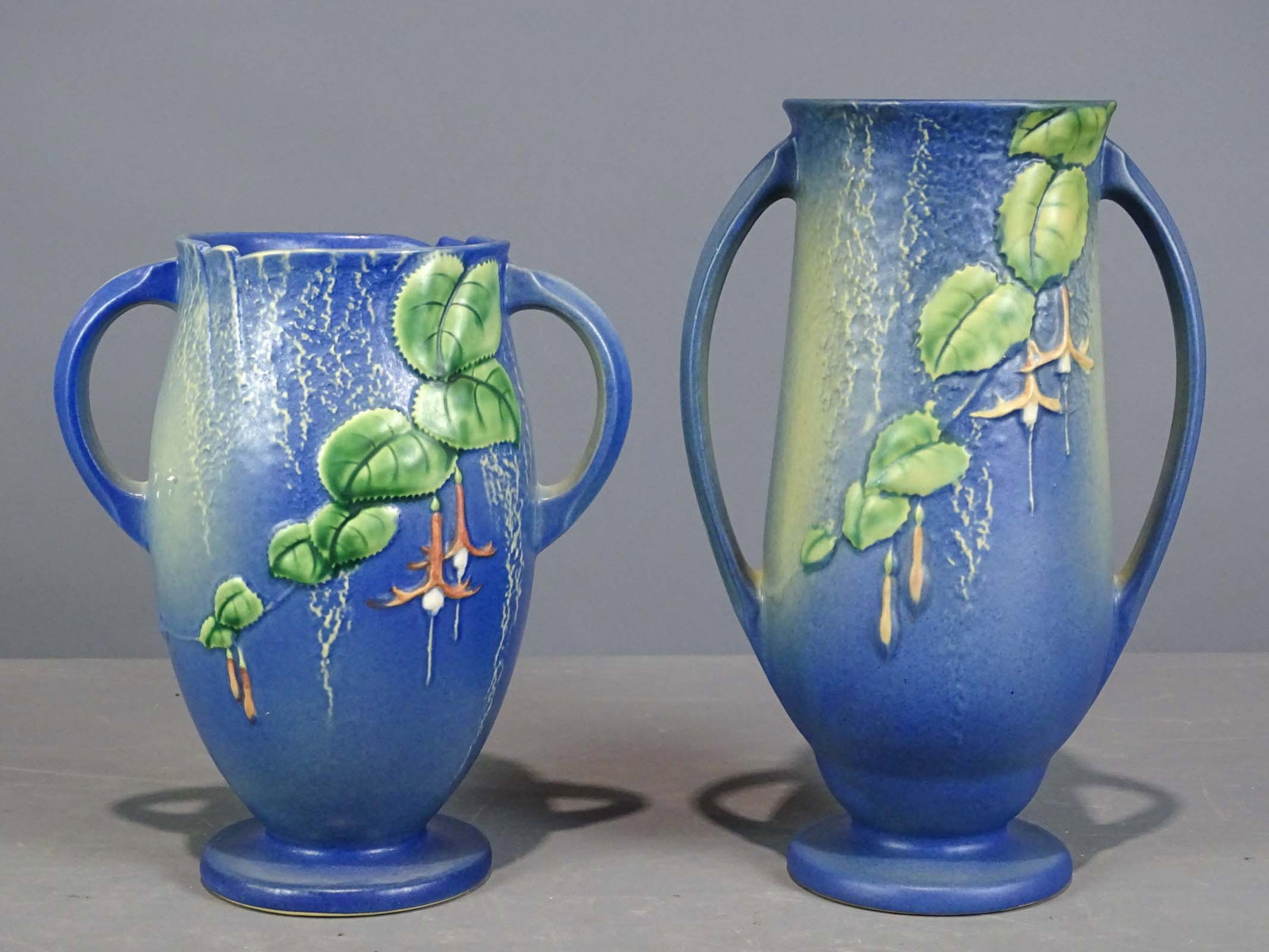 Roseville Lot: Lot (2) tall Roseville vases. Tallest 12 1/2" Ht.. Barbara Packer Collection. Good condition.