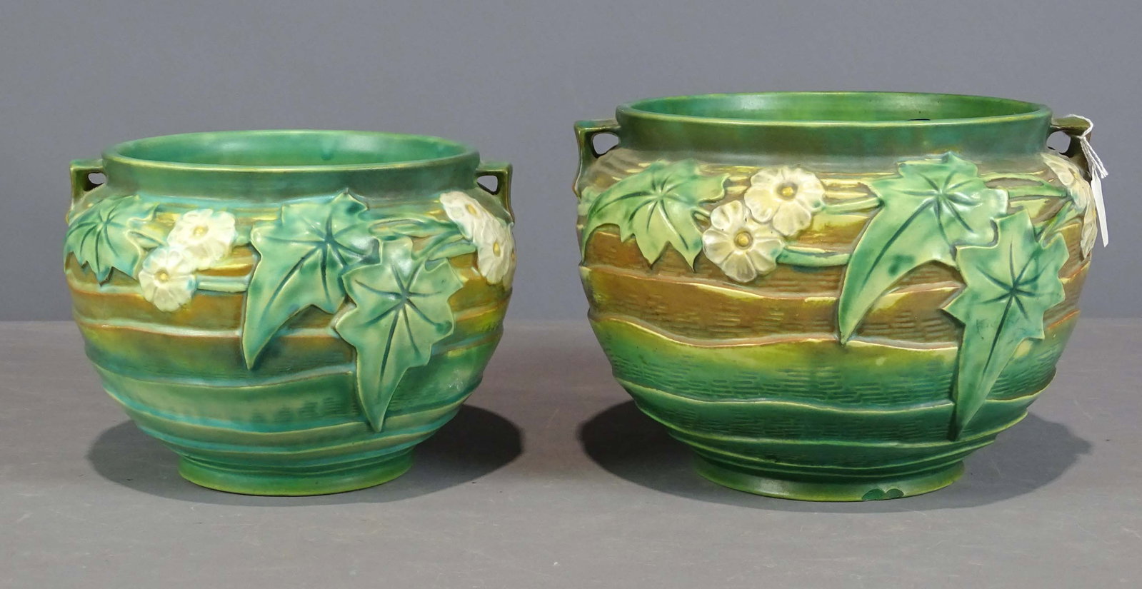 Roseville Lot: Lot (2) Roseville planters. Largest 12" D., 8 1/2" Ht.. (lines, chips to base), the other in good condition. Barbara Packer Collection.