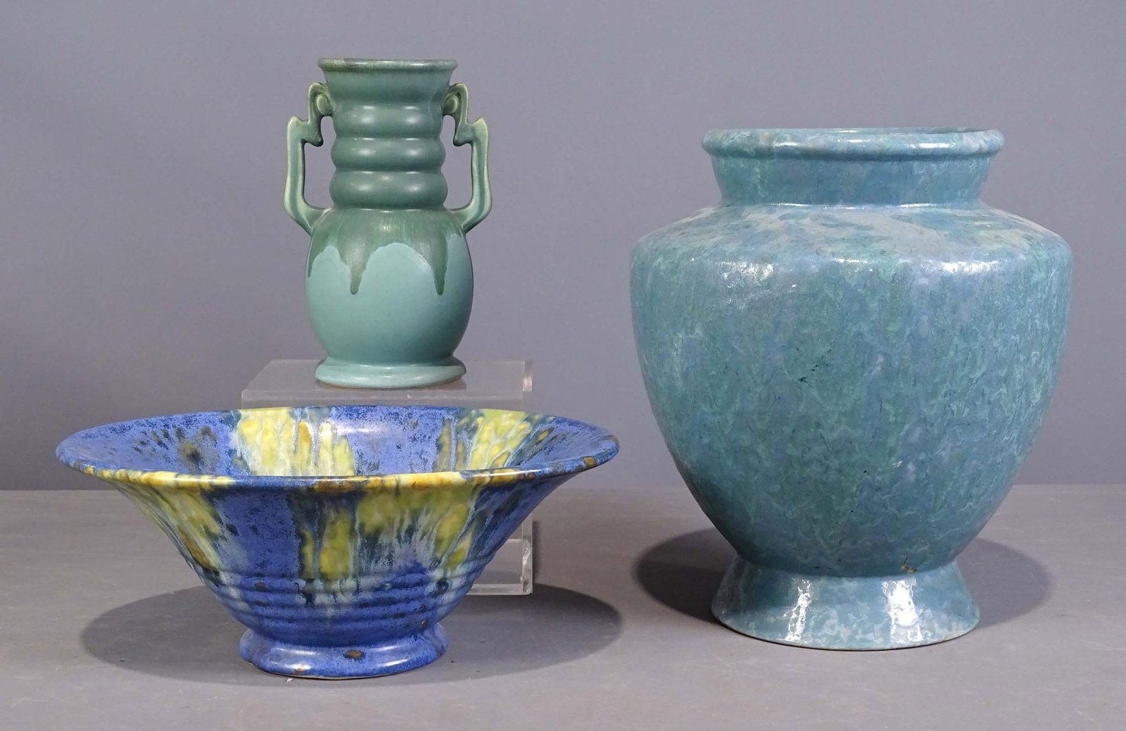 Roseville Lot: Lot (3) pieces of Roseville including tall vase (12" Ht.), bowl (12 1/2" L.), vase (8 1/2" Ht.). Barbara Packer Collection. Good condition.