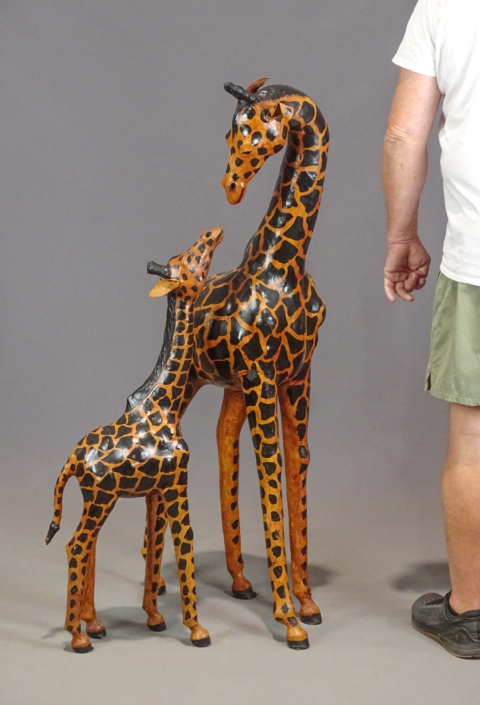Pair of Leather Giraffes: Pair of leather painted Giraffes. Tallest 47" Ht..