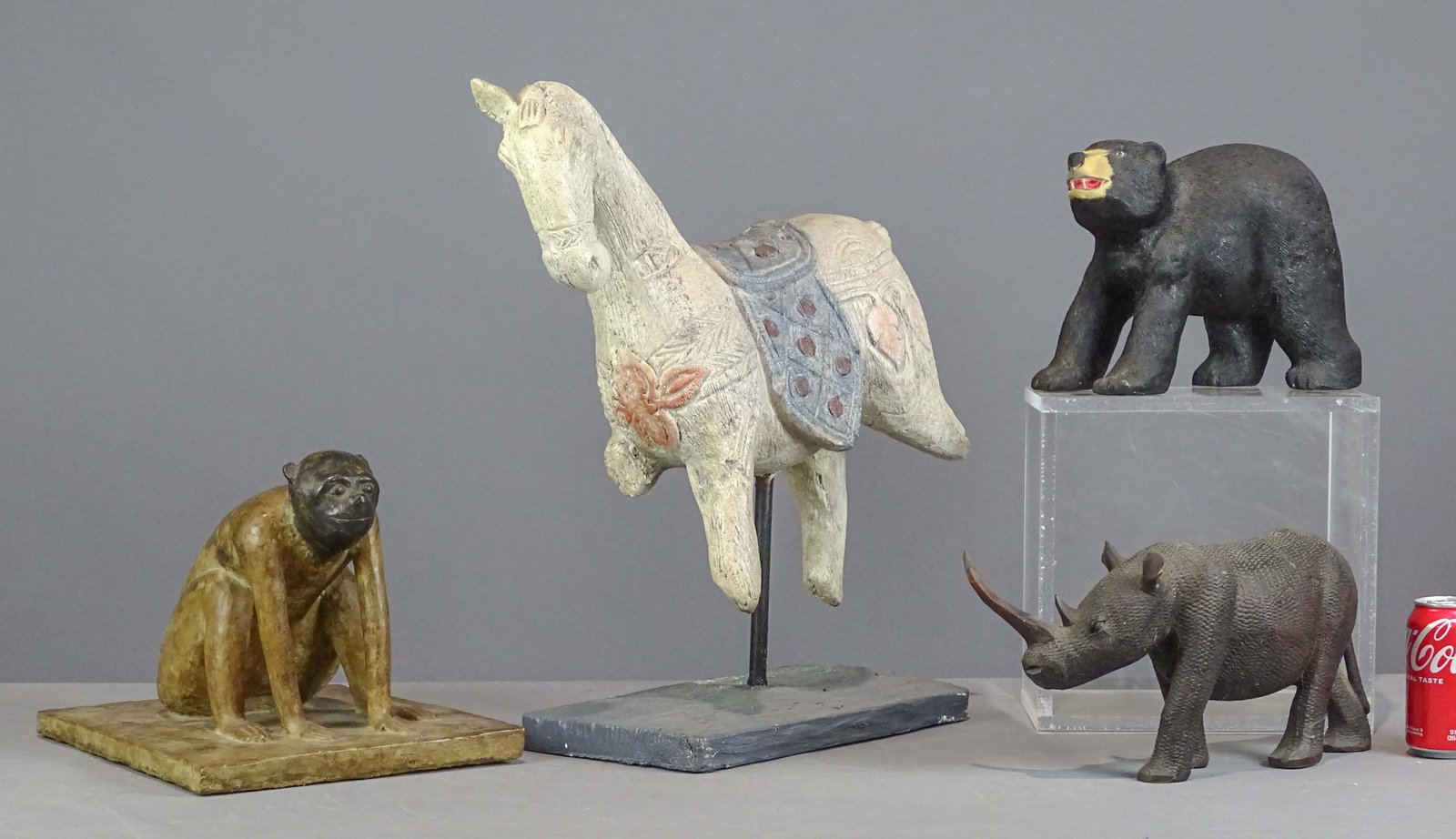 Lot of Carved Animals: Lot (4) carved animals. Includes wooden rhino (14" L.), composition monkey (10" Ht., neck cracked), composition bear signedc R. Dickman (8" Ht.), composition horse (22" Ht.).