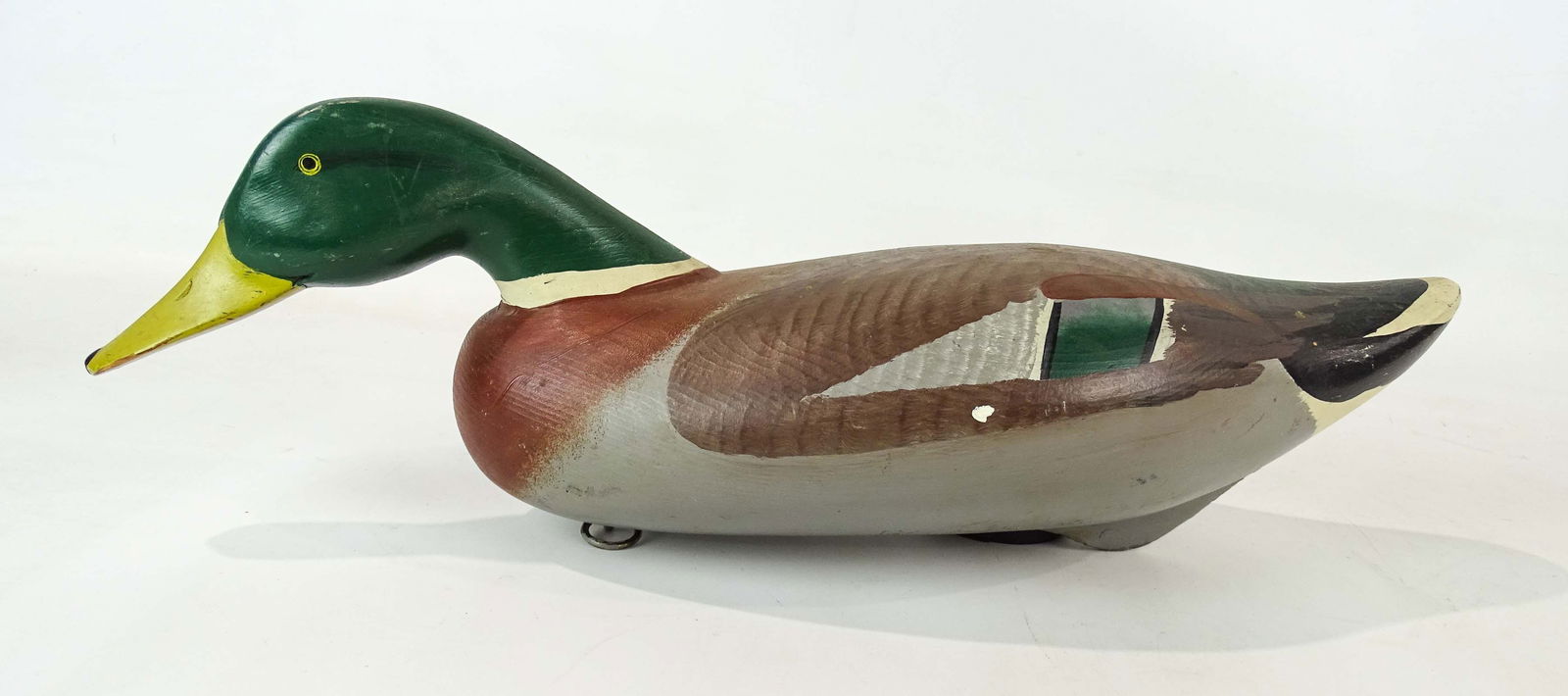 Decoy: Carved and painted wooden decoy. Marked underside "Patrick Vincenti Havre-De Grace MD.". 18 1/2" L..