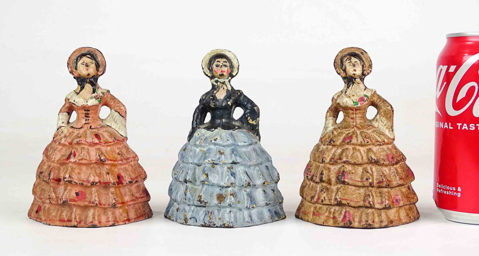 Antique Doorstops Southern Belle (3): Group of 3 early hand-painted cast iron doorstops, each a woman in bonnet and dress, sometimes referred to as Southern Belle. 5" Ht. each.