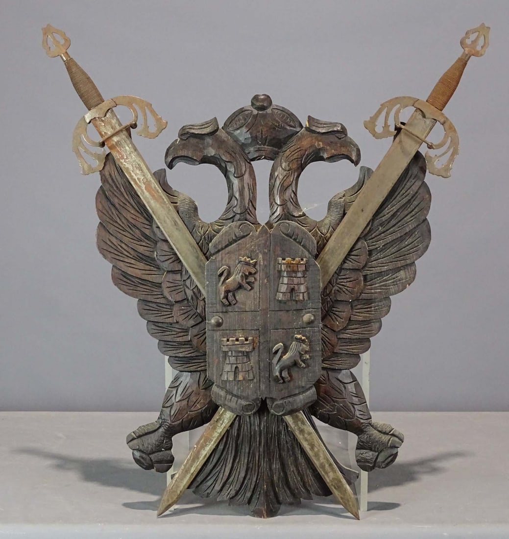 Wood Coat of Arms: Wooden carved coat of arms with swords. 39" x 31".
