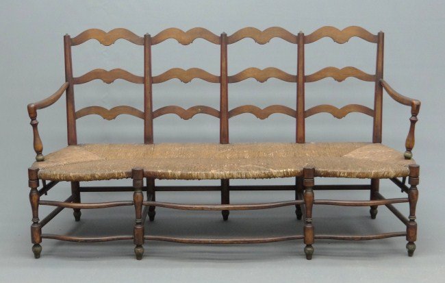 French Settee: French rush seat armed eight leg settee. 66" W 21" D 35" Ht.