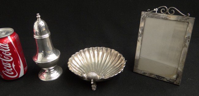 Sterling Silver Lot: Lot including signed Tiffany & Co. (Portugal) shell dish and Black Starr Gorham castor and Cartier frame with glass (6" x 4 1/2"). 623 total weight.