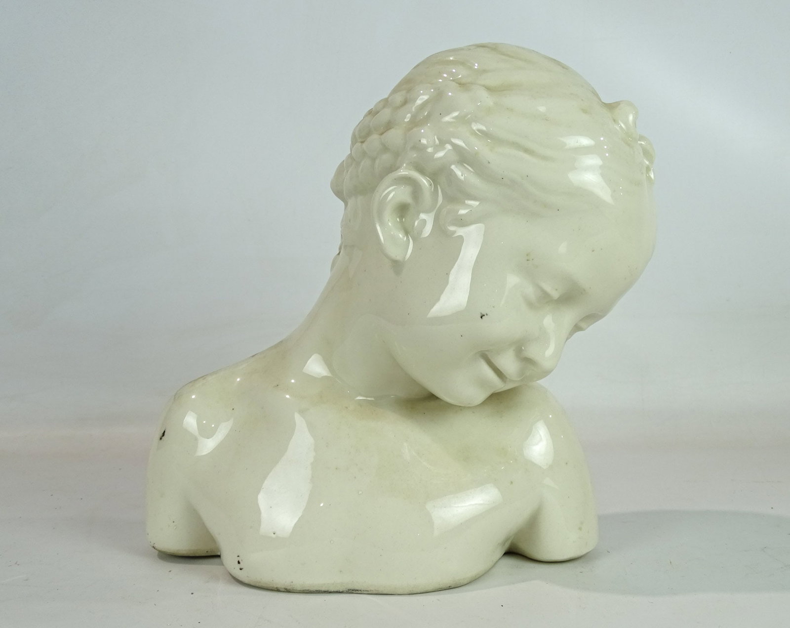 Porcelain Bust of a Woman: Porcelain bust of a woman. 11 1/4" Ht.. Unsigned.