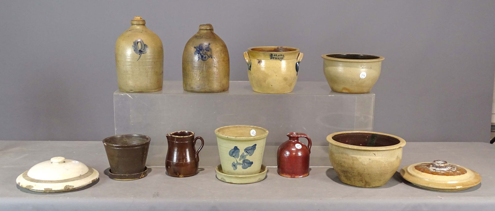 Stoneware Lot: Stoneware lot (11 pcs): N. Clark Athens handled crock 8 1/4" dia.; Mager & Co. Ithaca jug; W M E Warnth West Troy; flower pot; Albany flower pot; Albany glaze pitcher; redware jug; Evan R Jones, PItts