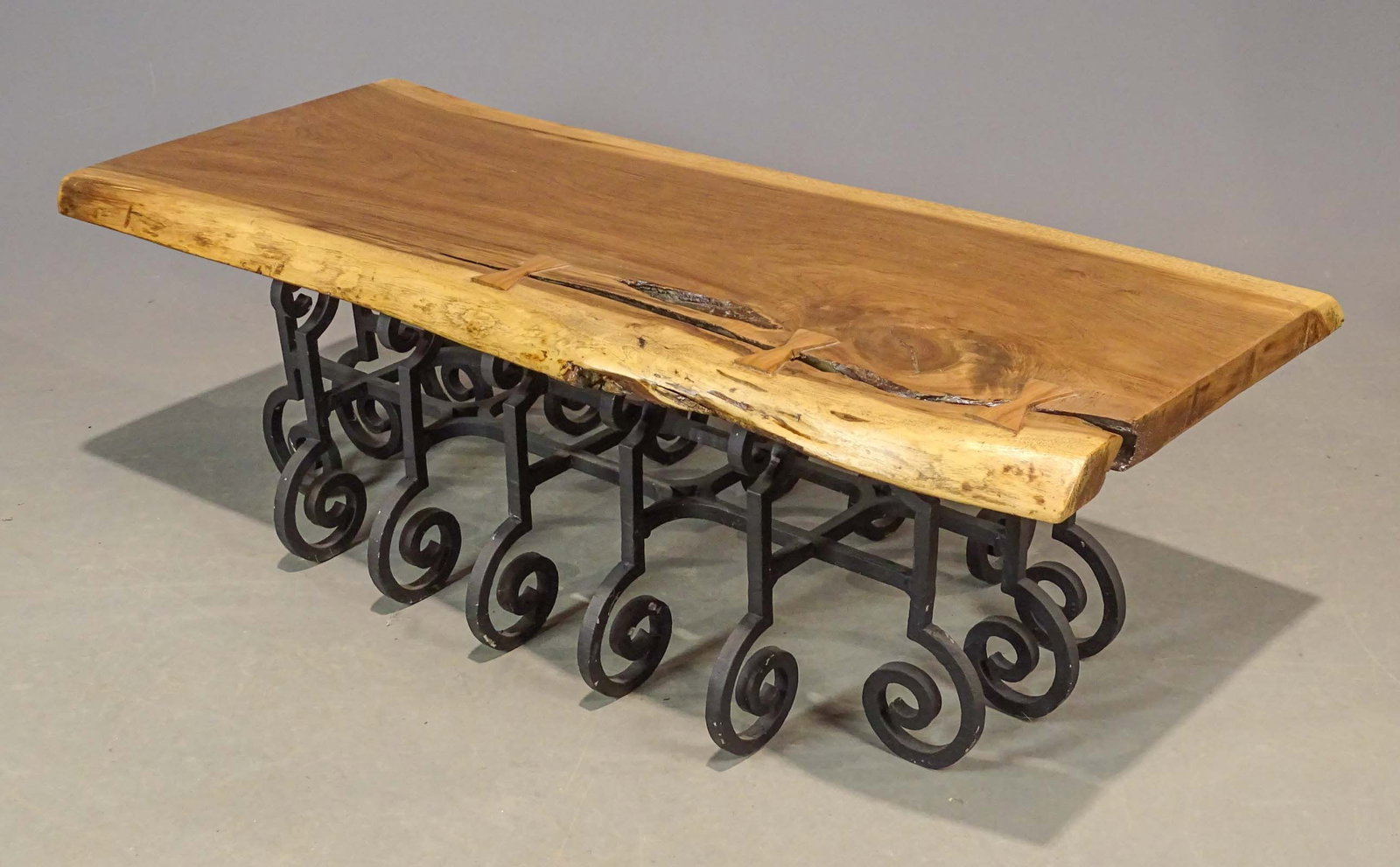 Live Edge Coffee Table: Live edge coffee table with wrought iron base. 51" x 21" x 16" Ht..