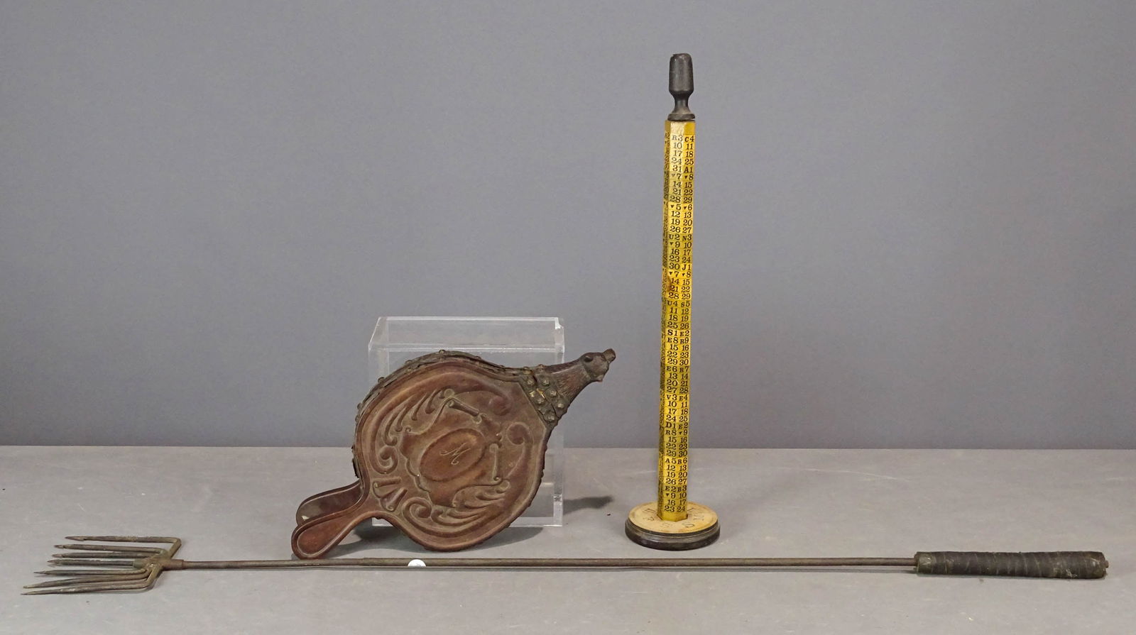 Misc. Lot: Lot including iron eel gig (57" L.), carved bellows with bear head (21" L.), measurer (28 1/2" Ht.).