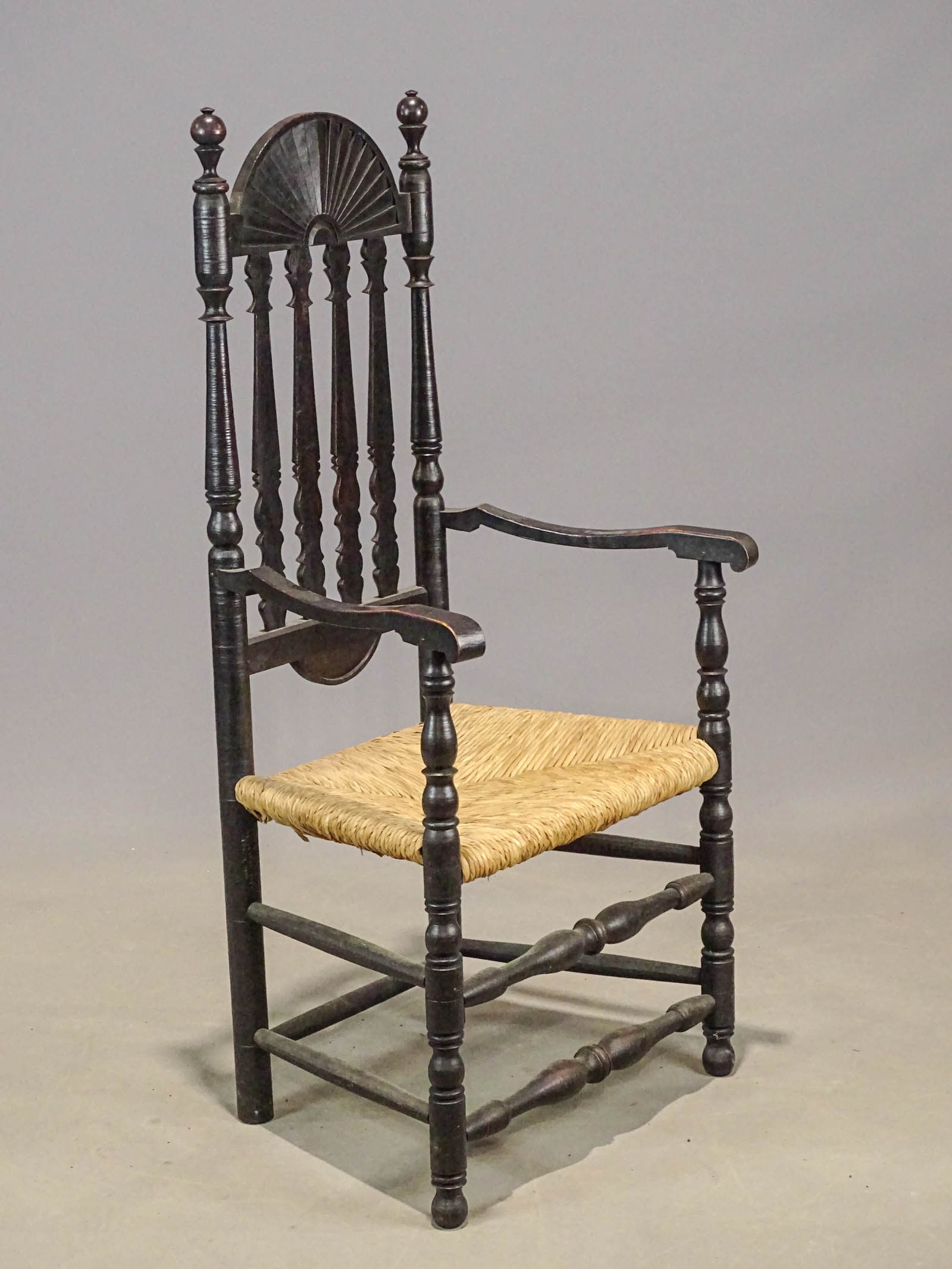 Benchmade Banister Back Armchair: Benchmade Banister back armchair in black paint. Rush seat. 18" seat Ht., 50 1/2" overall Ht..