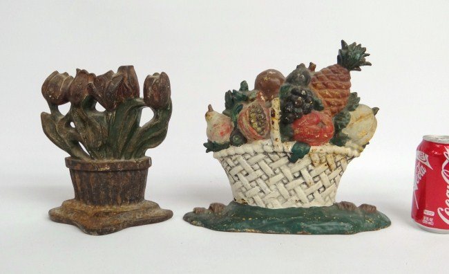 Doorstops: Lot two cast iron doorstops baskets of flowers. 8 1/2" and 9 3/4" Ht. Ex: Guennol Collection.
