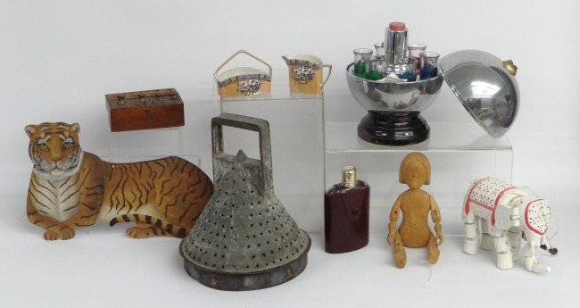 Misc. Lot: Misc. lot including vintage chrome case Deco cordial set (finial broken), carvings, Noritake cream and sugar, bottle, scale weights, flat metal lion decoration, primitive strainer. vintage spread