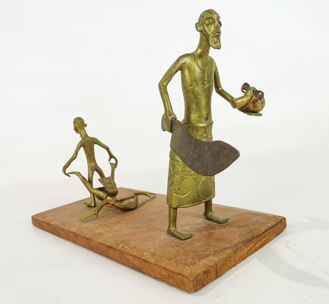 African Sculpture: African brass wood base sculpture of a beheading. 9" x 4 1/2" x 6".