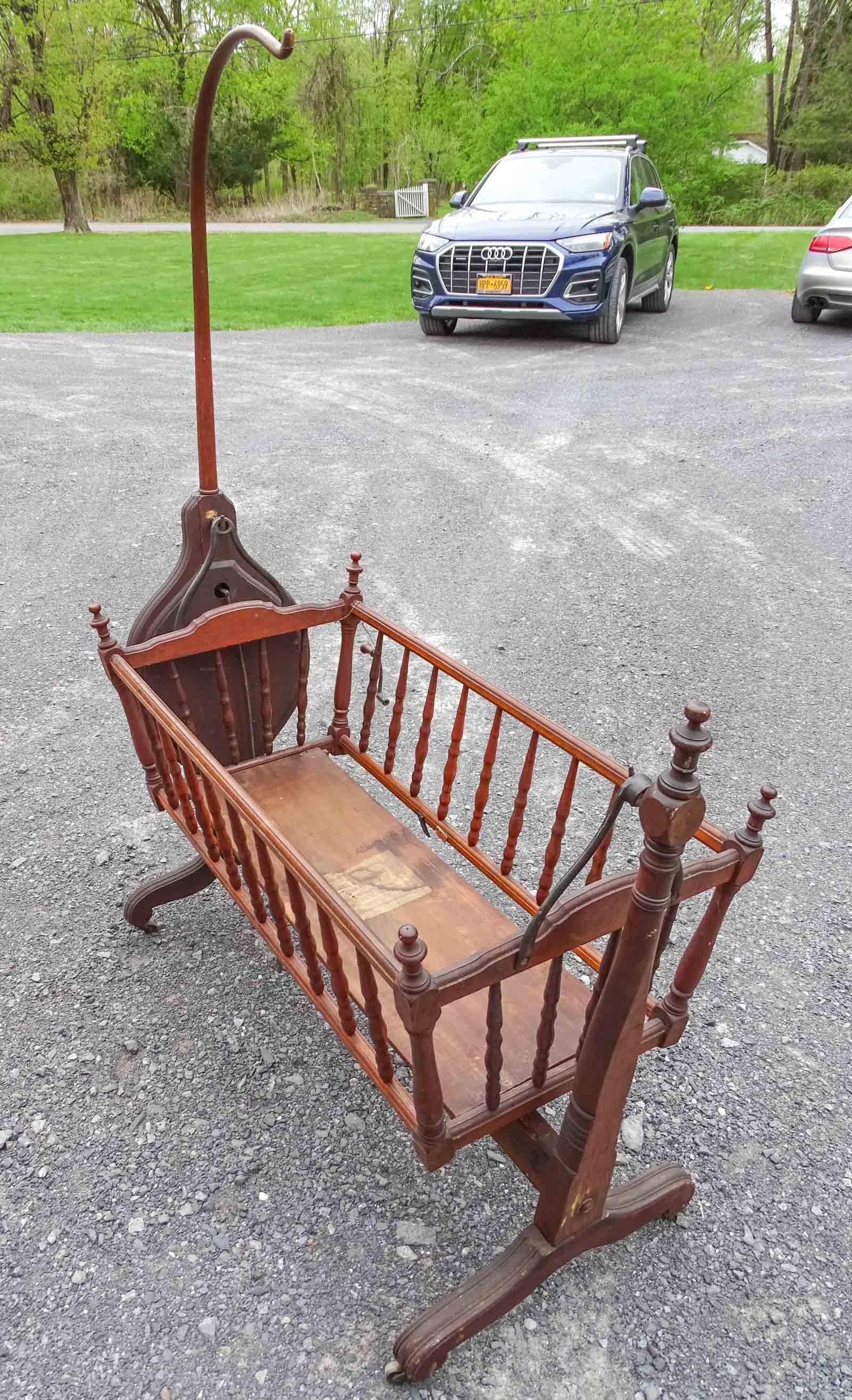 Child's Rocking Crib: Early windup child's rocking crib. Labeled Blake and Davenport Boston. 44" x 20" x 60" Ht..