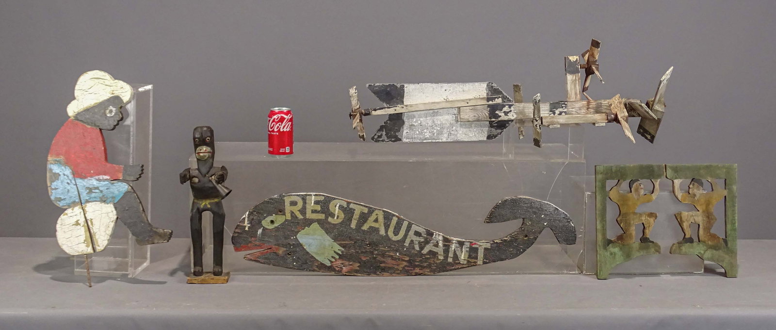 Folk Art Lot: Folk art lot including carved figure (16" Ht.), yard figure (21" L.), whirligig (31" L.), whale carving (35" L.), (2) folk art brackets (11 1/2" x 7").