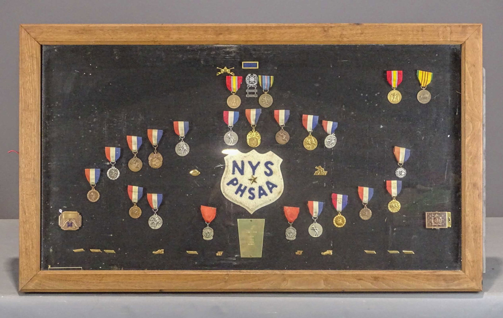 Wall Case with Medals: Wall case with medals. Includes track, military. Overall 24" x 42", 3" thick.