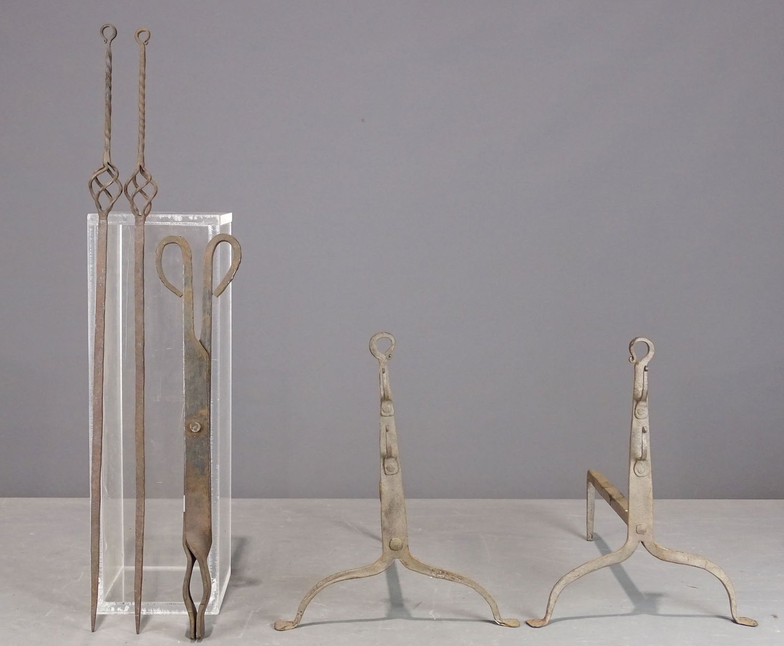 Metalware Lot: Metalware lot including pair of andirons (13 1/2" Ht., 13 1/2" D.), tongs (18 1/2" L.), pokers (27 1/2" L.).