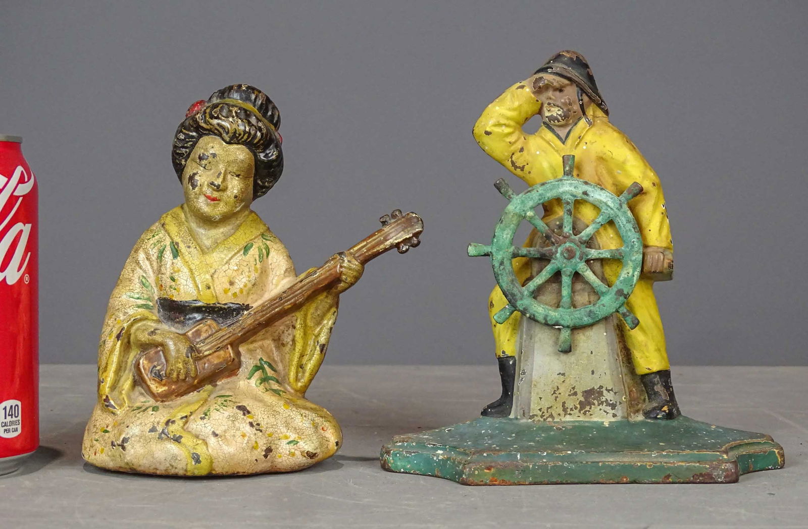 Doorstops: Lot (2) doorstops including Gloucester Fisherman at Wheel (cast iron, 6 1/8" Ht., Spencer Foundry, Guilford Ct.), and Geisha Girl (cast iron, 5 5/8" Ht.).