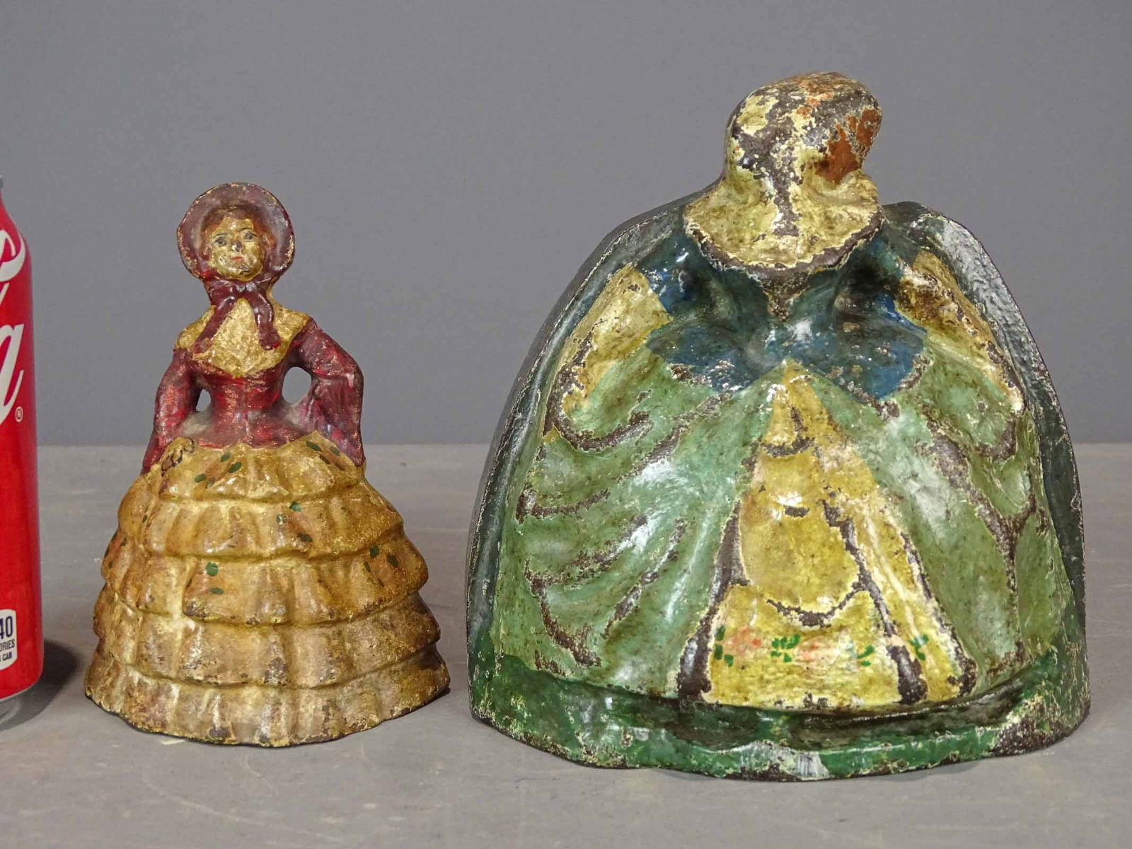 Doorstops: Lot (2) doorstops including Lady in Hoopskirt, cast iron, 5 7/8" Ht.; Little Colonial Lady, cast iron, 4 3/4" Ht., full figure.