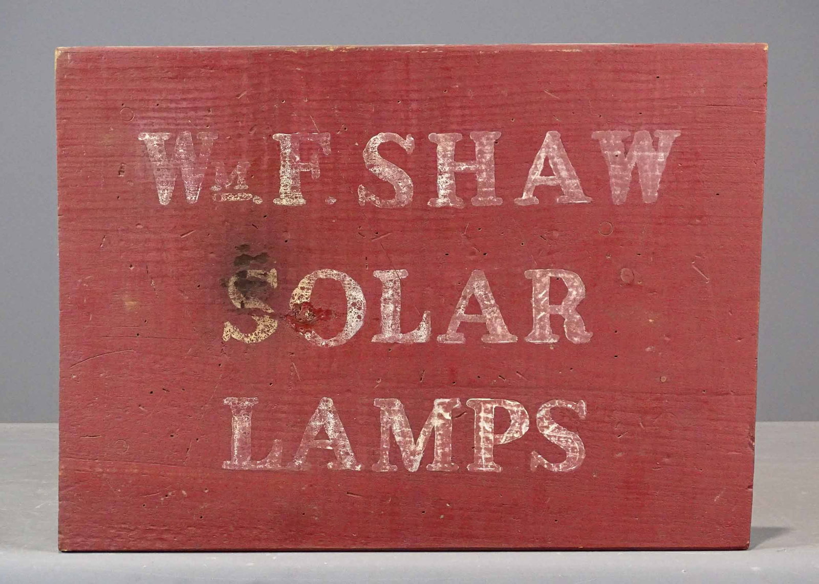 Trade Sign: Early painted wooden trade sign "Wm. SHAW SOLAR LAMPS" (label verso). 14" x 19".
