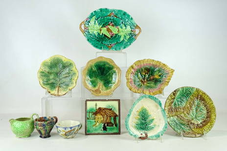 Majolica Collection: Majolica collection: (6) plates & platters, largest 10" dia.; (2) coffee cups; creamer; tile. 10 pcs. (imperfections).