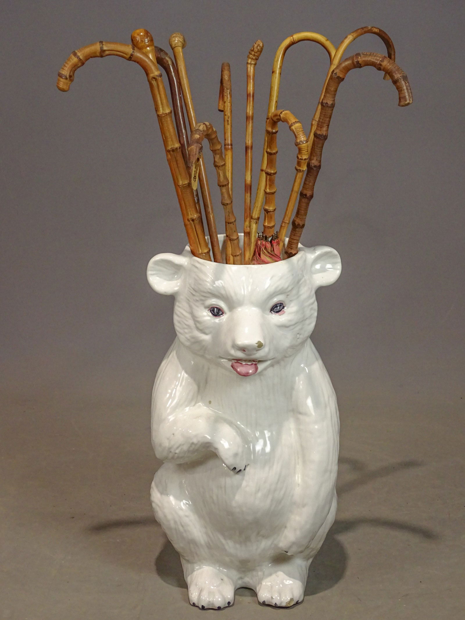 Italian Bear Umbrella Holder.: Italian Bear Umbrella Holder (22 1/4" Ht.), with Bamboo canes and umbrella.Mid-20th c. Italian glazed bear umbrella holder with a collection of antique and vintage bamboo canes/ walking sticks and umb
