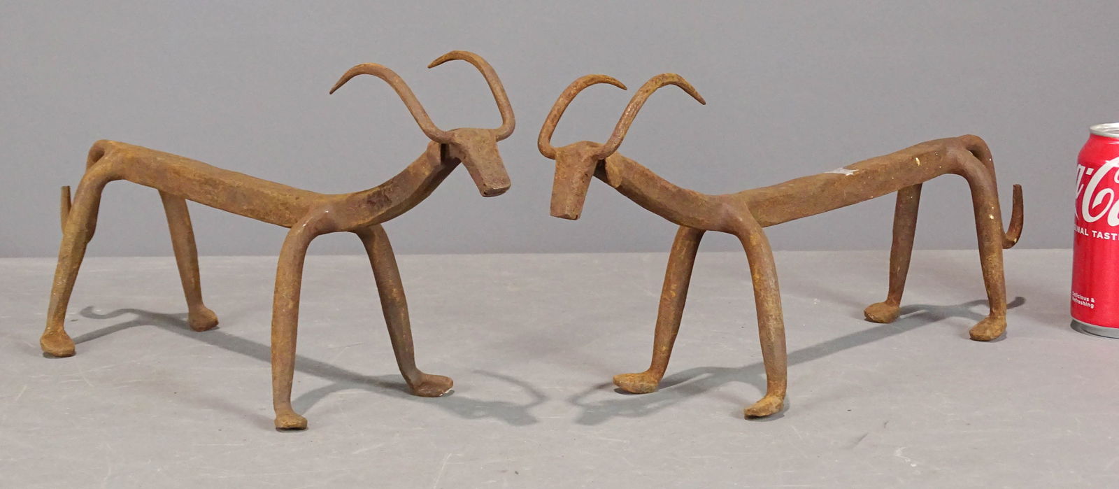 Fire Dogs: Pair of iron Steer head fire dogs. 8" Ht., 16" L..