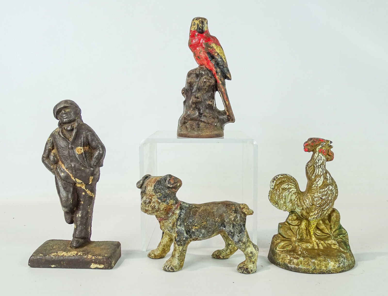 Doorstop Lot: Lot (4) early cast iron doorstops including rooster (6" Ht.), Parrot (6 1/2" Ht.), dog (4 1/2" Ht.), figure (7 1/2" Ht.).