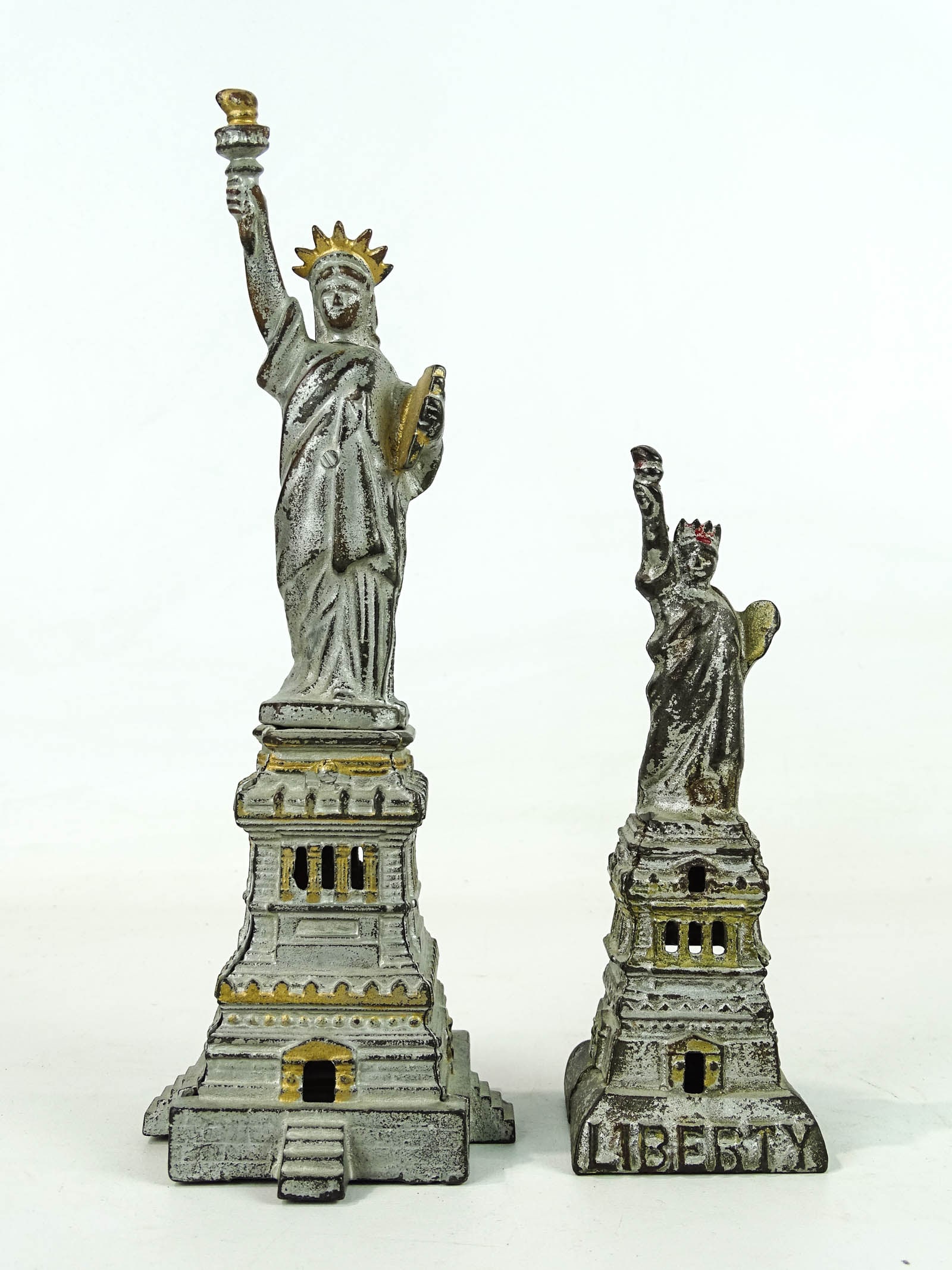 Statue of Liberty Banks: Lot (2) Kenton cast iron Statue of Liberty banks. 6 3/8" and 9 5/8" Ht..