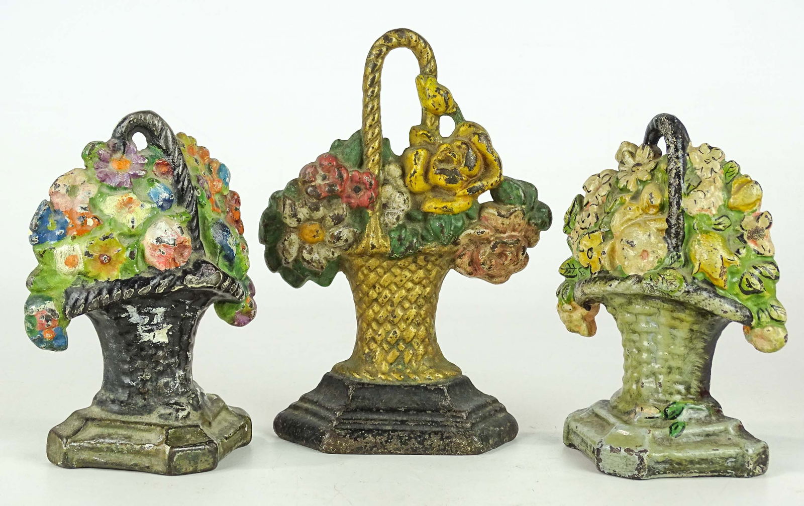 Doorstop Lot: Lot (3) cast iron flower basket doorstops. Tallest 7" Ht..