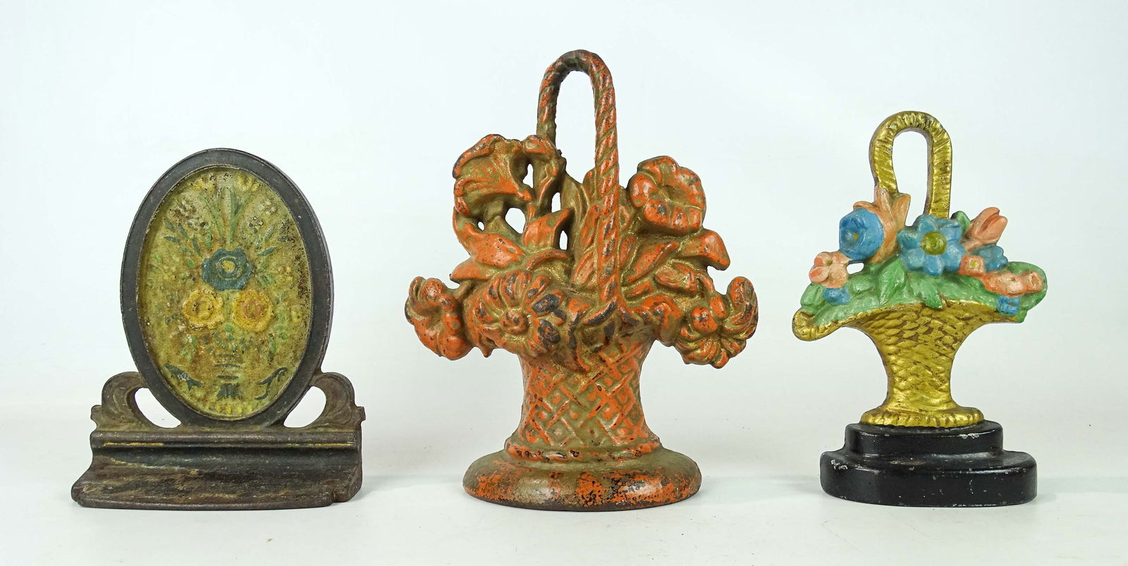 Doorstop Lot: Lot (3) cast iron floral doorstops. Tallest 10" Ht..