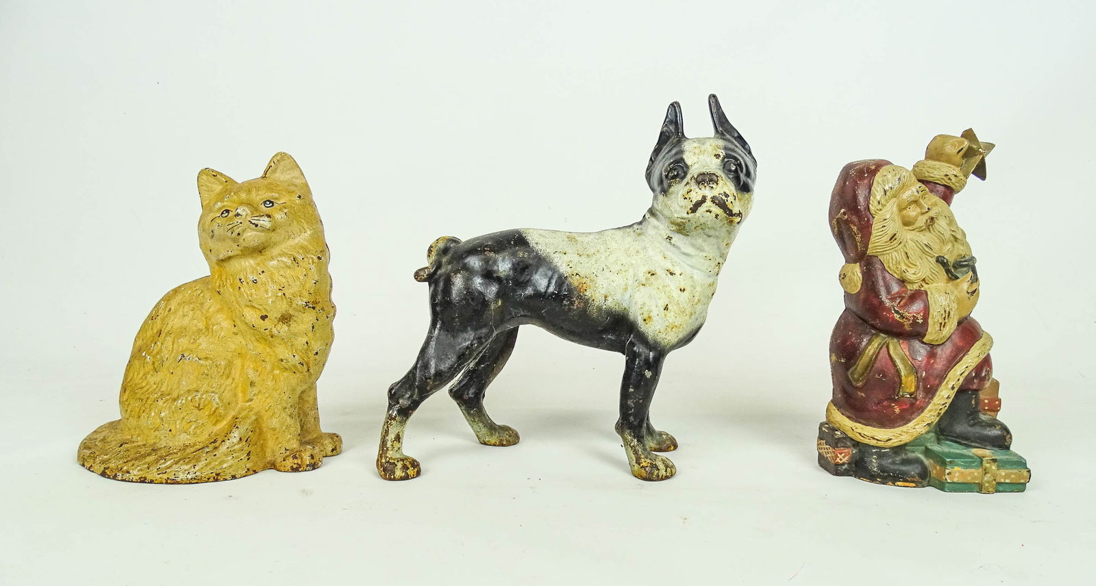 Doorstop Lot: Lot (3) cast iron doorstops including Boston Terrier (8" L., 10 1/2" Ht.), cat (9" Ht.), Santa Claus (10" Ht.).