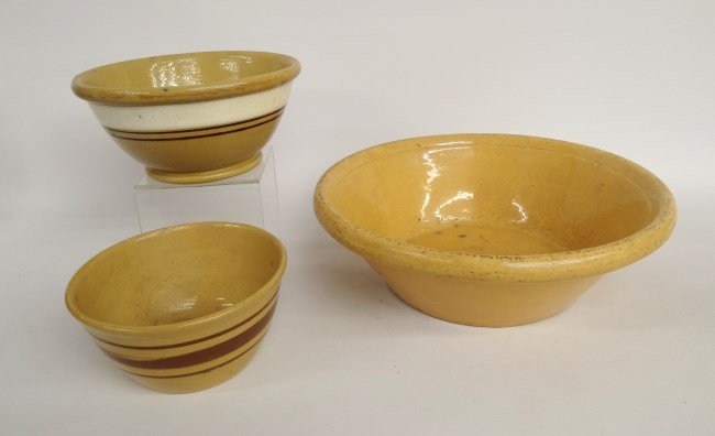 Yelloware Lot: Lot three early yelloware kitchen bowls, two with band decoration. 7", 8 3/4" and 14" Diameter.