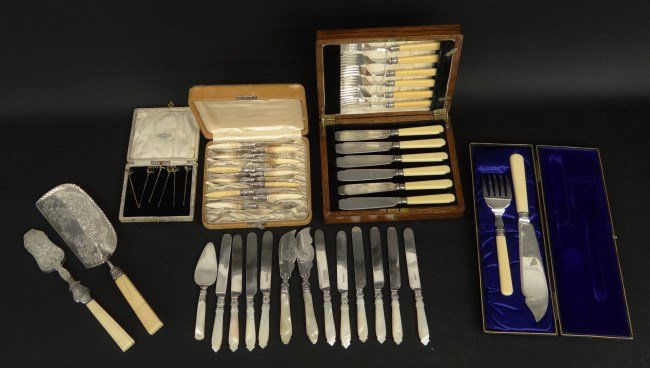 Sterling Silver Lot: Lot including boxed sterling silver pins, boxed sets of knives, pearl handled flatwear and celluloid handle serving pieces.