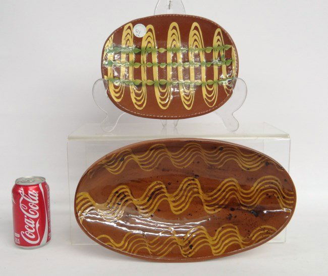 Redware Lot: Lot two redware plates. 10 1/4" and 15" Length. Both signed illegibly.