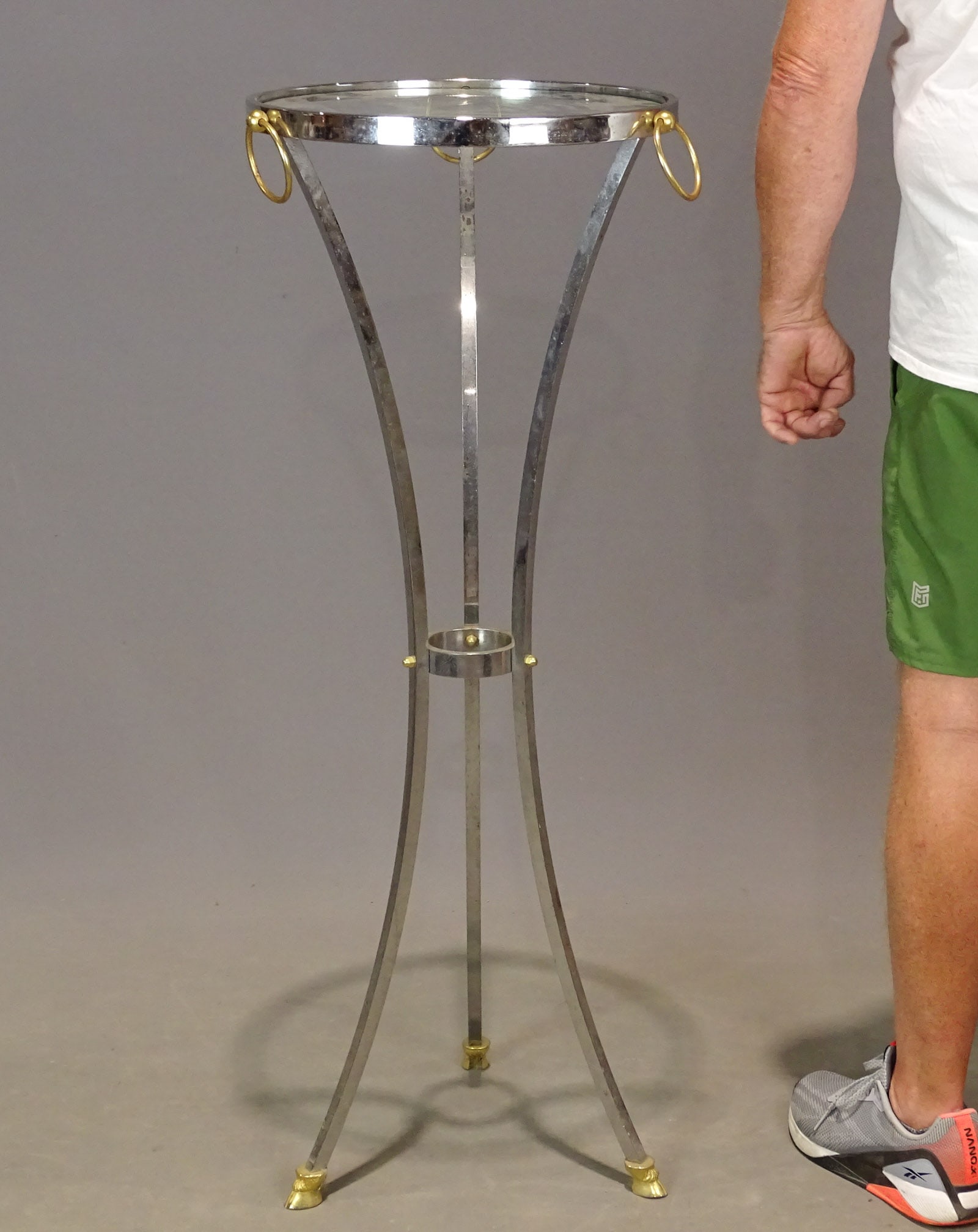 Plant Stand: Chrome and brass, hoof foot plant stand with glass shelf top. 42" Ht. 15 1/2" D.