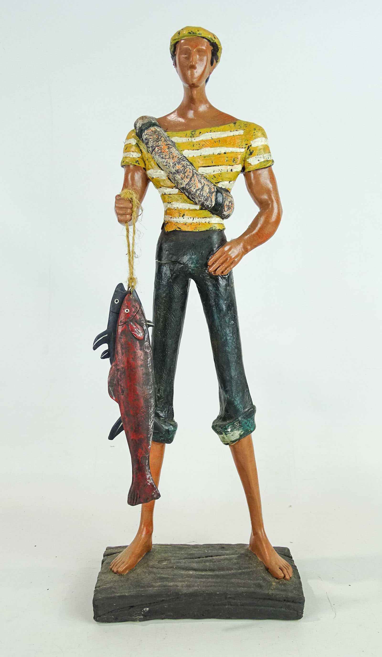 Decorative Figure of Man with Fish: Decorative figure of a man with fish. 18" Ht., 6 1/2" W..