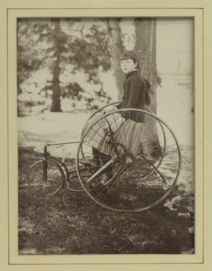 Photograph Cyclist: c. 1887 photograph of young girl on an adult tricycle. Identified as "Nell" april 7, 1887. Site 8" x 6" . Very good condition. Pedaling History Museum Collection.