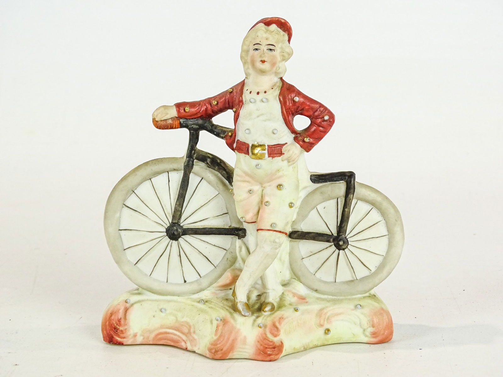 German Bisque Statue: German bisque statue. Woman with boneshaker. 5 1/2" Ht..