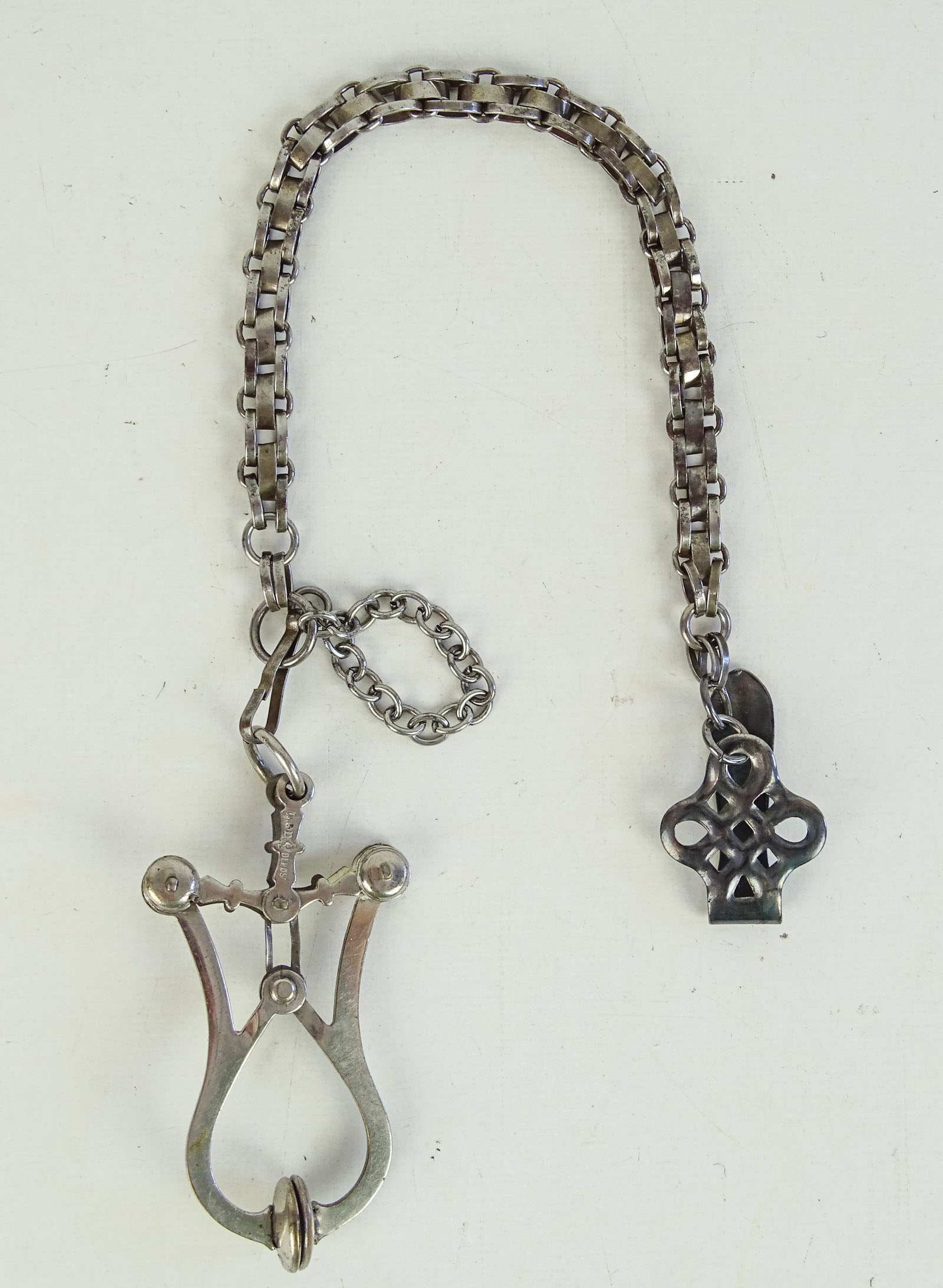 Victorian Skirt Lifter: Victorian skirt lifter. Marked L & D Depose. 12" L.. Good condition. Dave Walker Collection.
