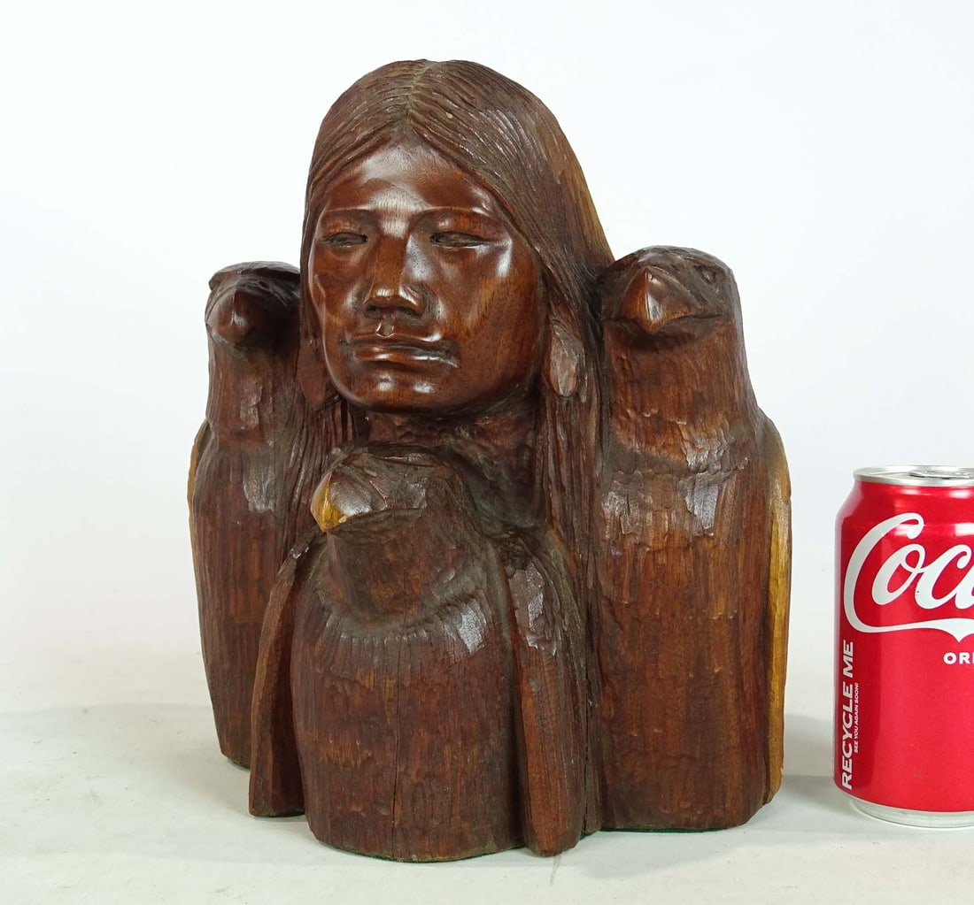 Bruce Wynne Wood Carving: Bruce Wynne Native American wood carving, figure with (3) eagles. 9" W., 11" Ht., 7" D.. Please note items must be removed/picked up/shipped within 2 weeks after the auction.