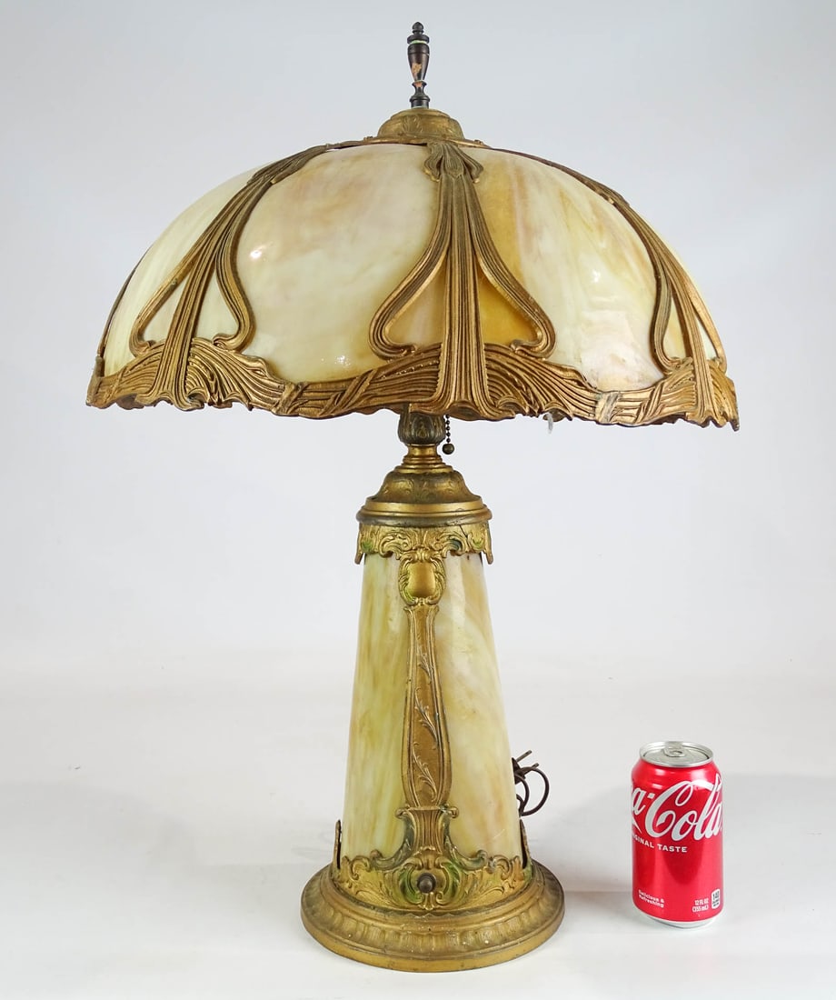 Slag Glass Lamp: Slag glass lamp. One panel cracked. 25" Ht. It does have a bulb and switch for the base to light up. Please note items must be removed/picked up/shipped within 2 weeks after the auction.
