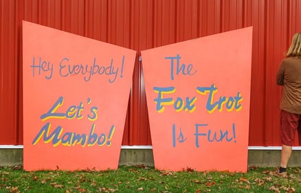 Pair of Large Oil Dance Signs