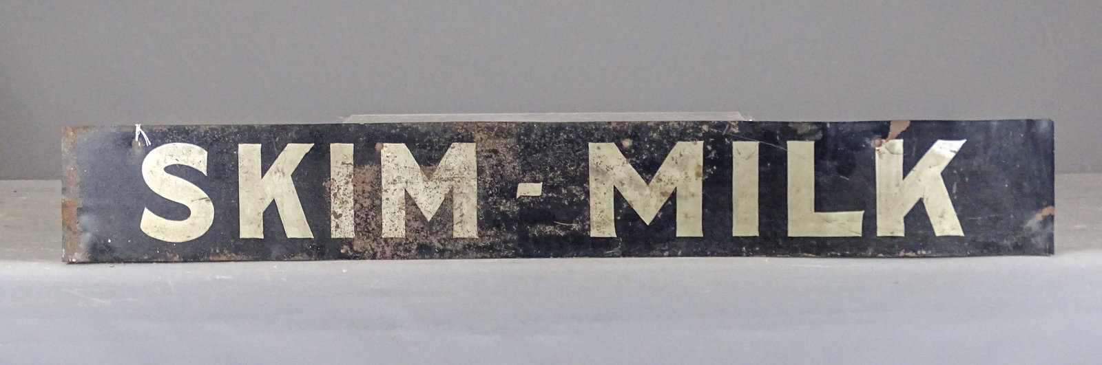 Trade Sign: Early sheet metal trade sign "SKIM-MILK". 6" x 44".